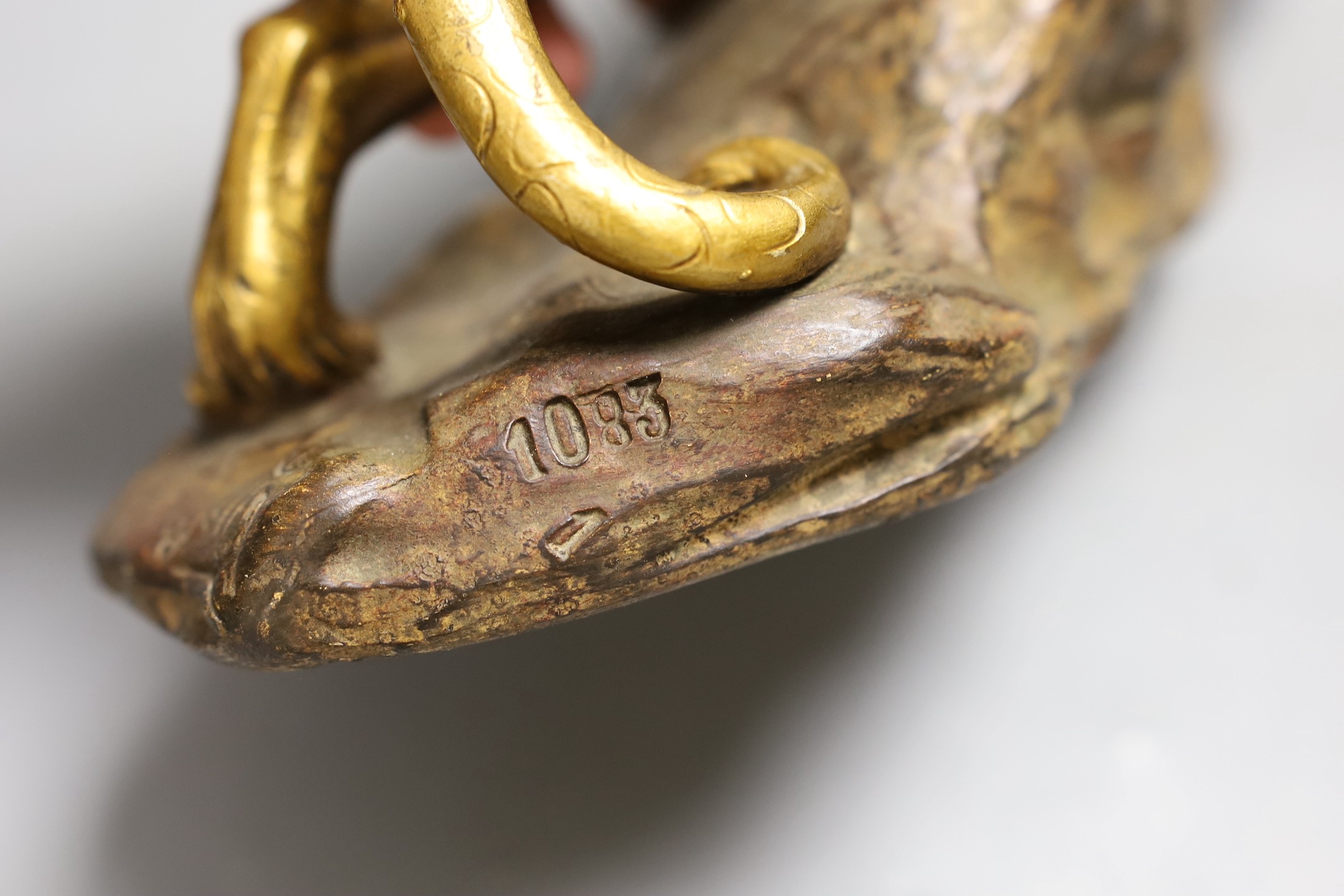 A gilt terracotta model of a panther on a rock, 21cms high